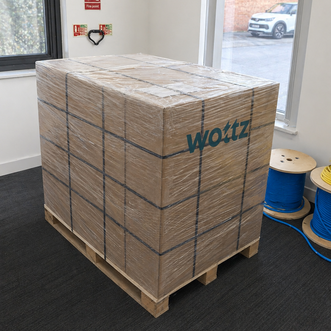 Wottz-branded pallet of EV charging cables wrapped for shipping in the warehouse with cable reels nearby